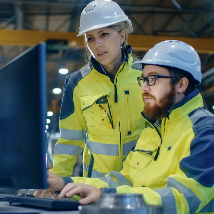 Two staff members monitoring computer screens