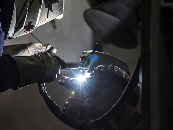 Technician welding a drill bit