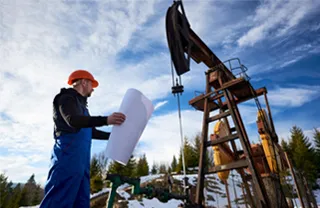 Drilling engineer reviewing blueprints at the job site